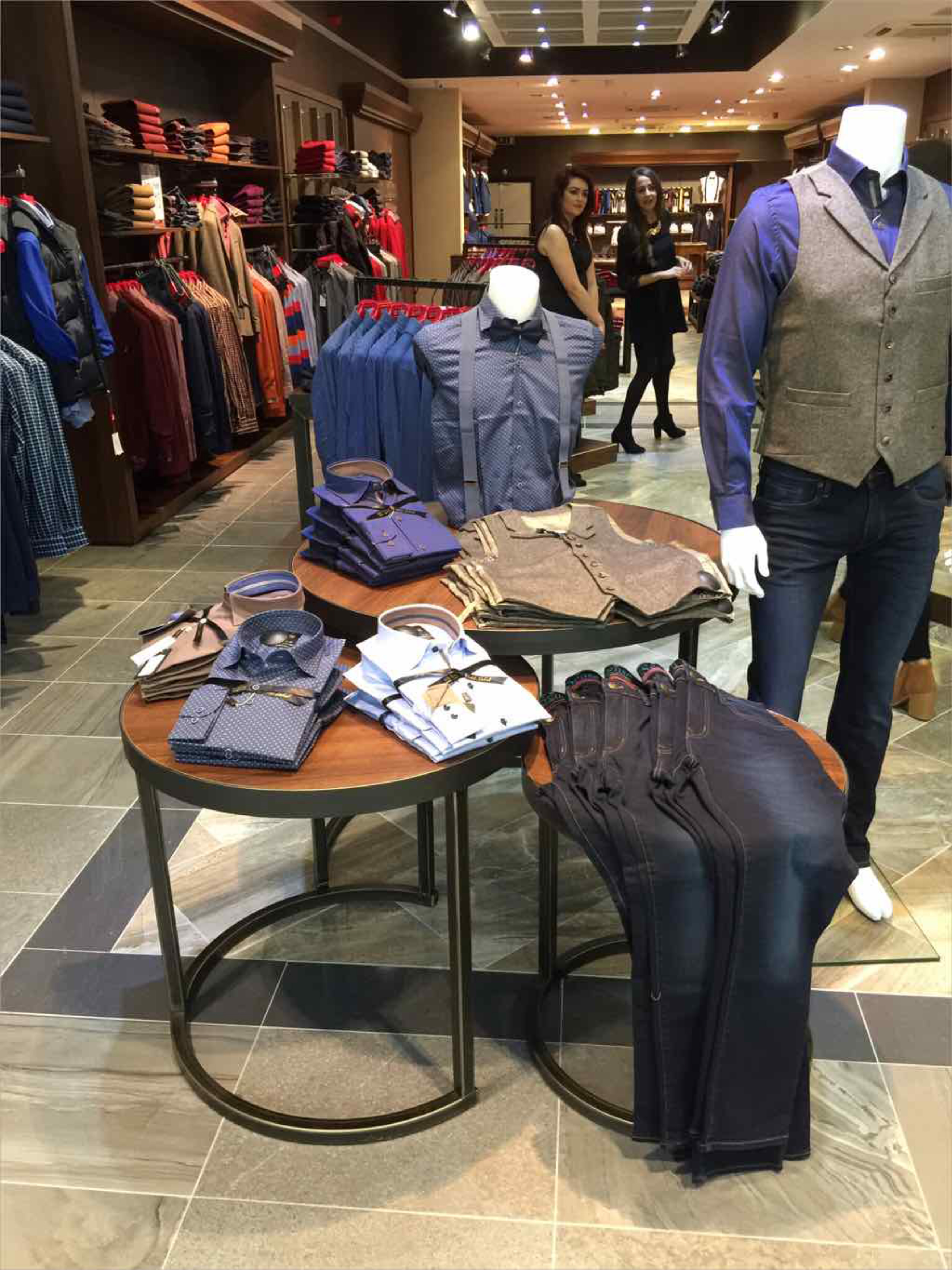 Display tables showing shirts and jeans menswear